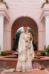 Hand embroidered short shirt and sharara set with dupatta, embellished with beads, cutdana, and sequins.