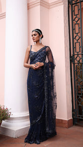 Exquisite royal blue saree with sparkling floral details and intricate beadwork.