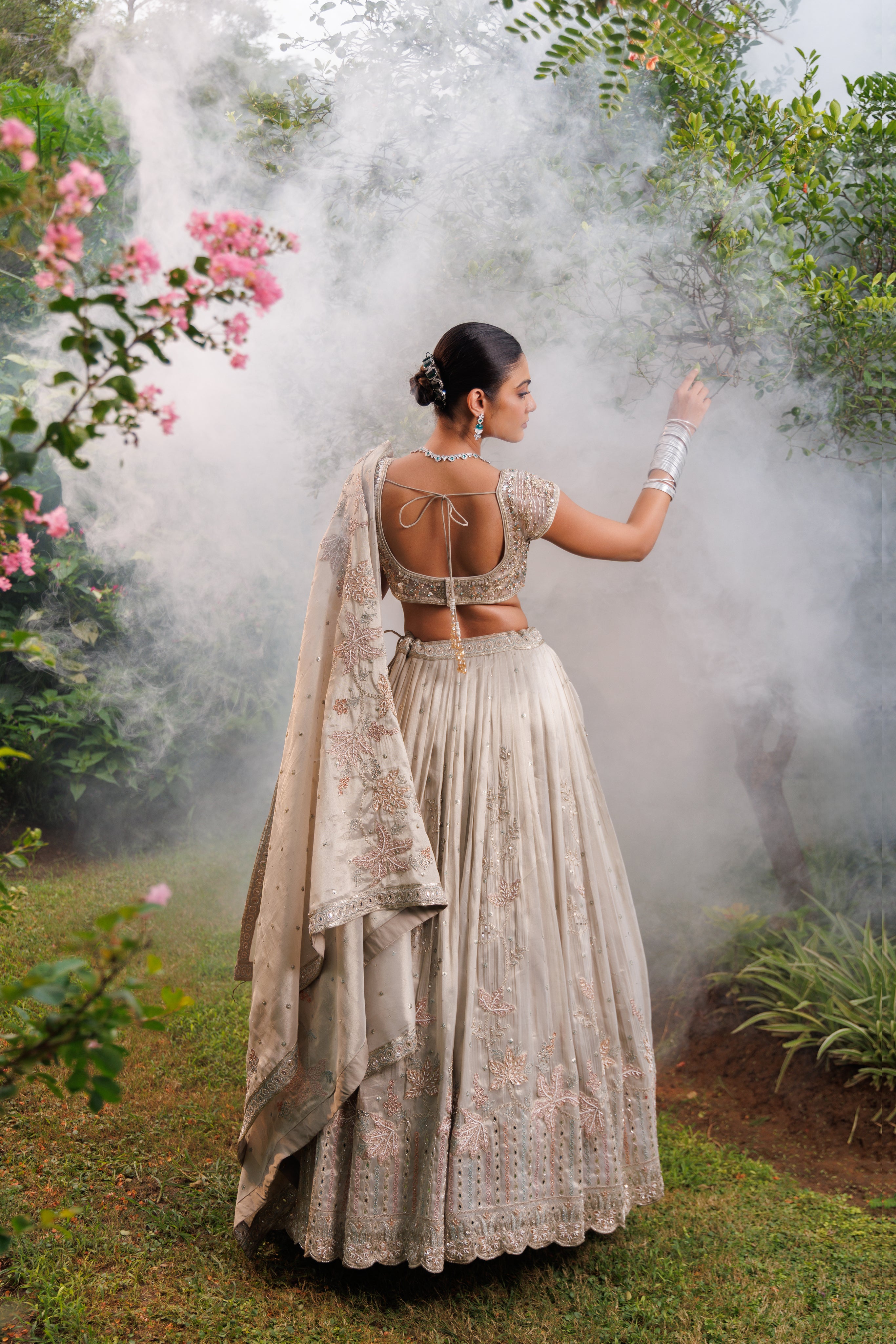 Pastel Beige lehenga with floral detailing, sparkle, and intricate beadwork for a graceful bridal look.