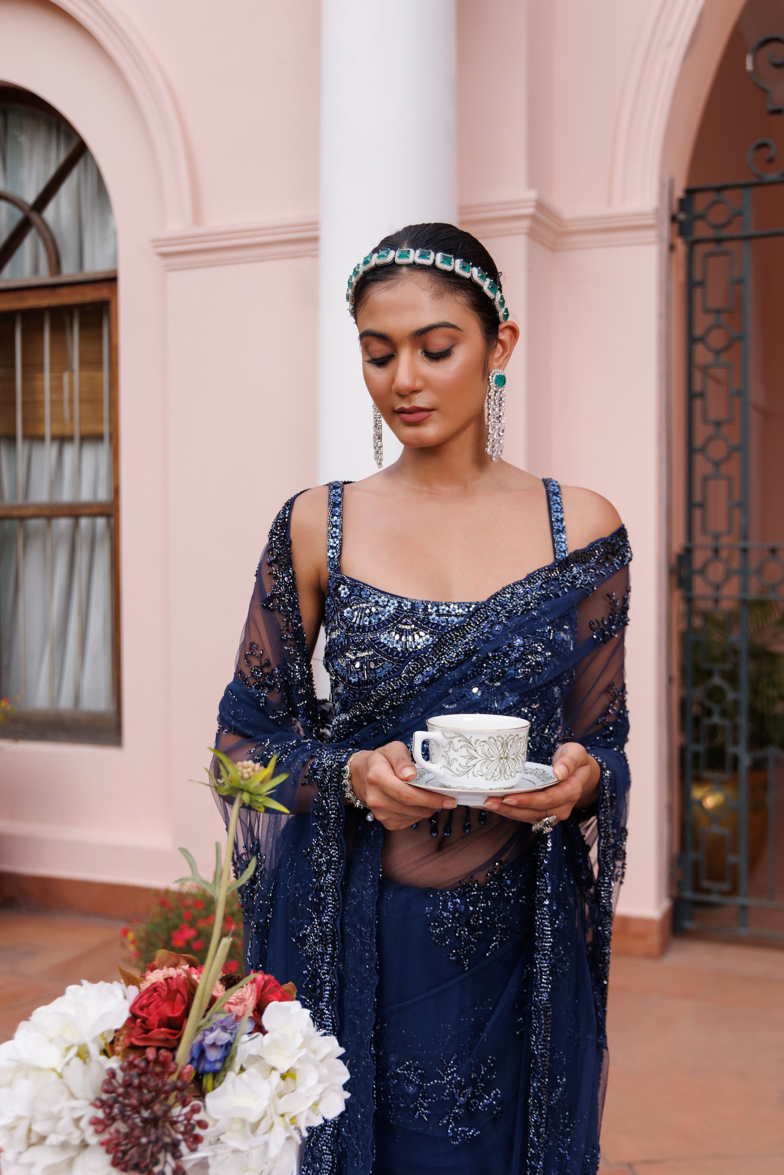 Exquisite royal blue saree with sparkling floral details and intricate beadwork.